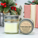 Jar candle with decorative label on a surface with Christmas decorations in the background